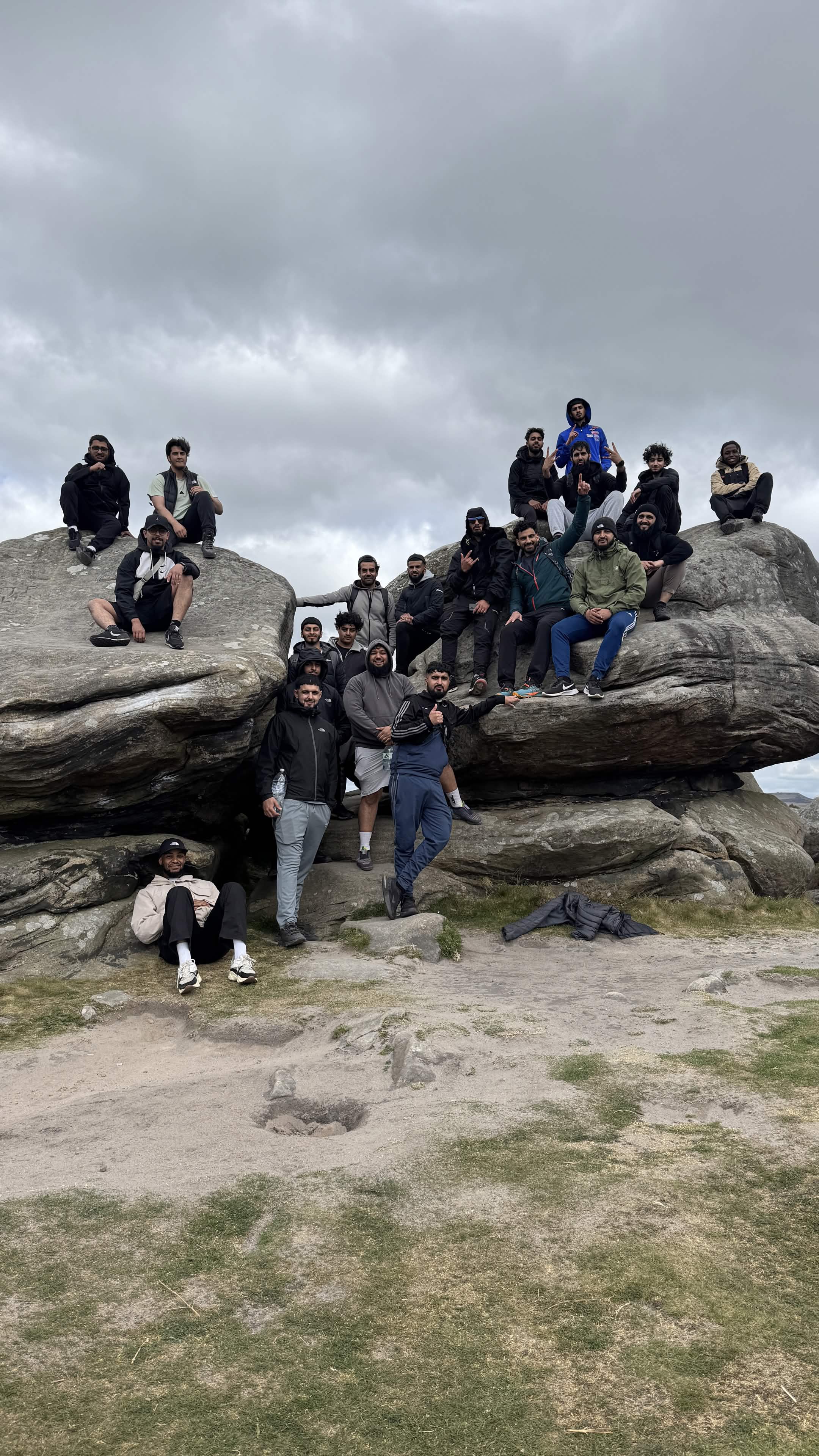 Group celebrating together on top of a Peak District summit
