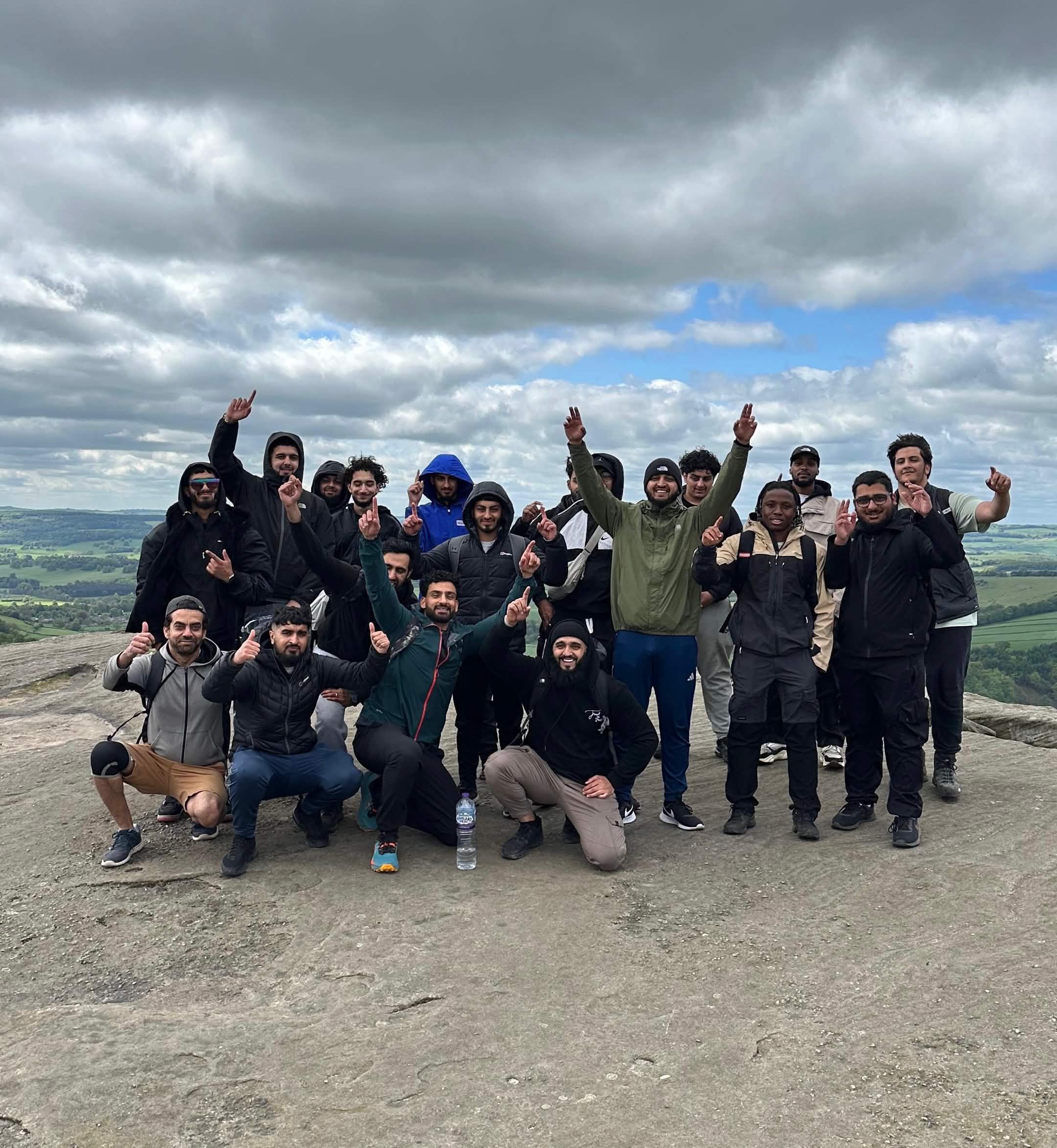 Group cheering on a rocky outcrop